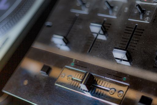 A closeup shot of a part of a music mixer controller