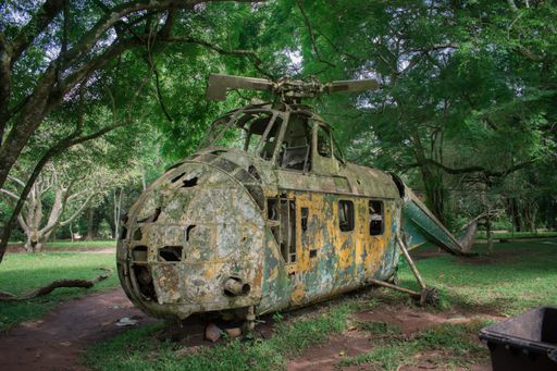 A vintage military abandoned helicopter in the Aburi Botanical Gardens in Ghana