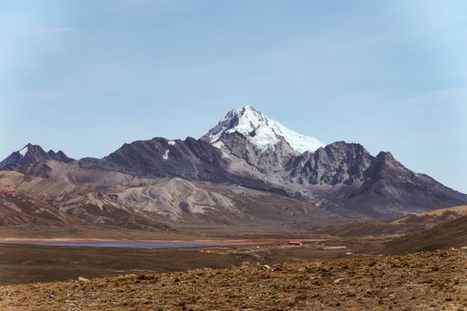 Mountain peak with snowy summit and clouds in the sky
