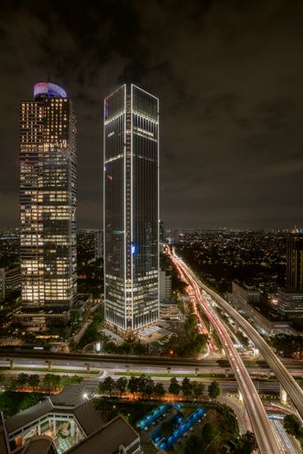 Aerial view of downtown cityscape at night with traffic on illuminated streets