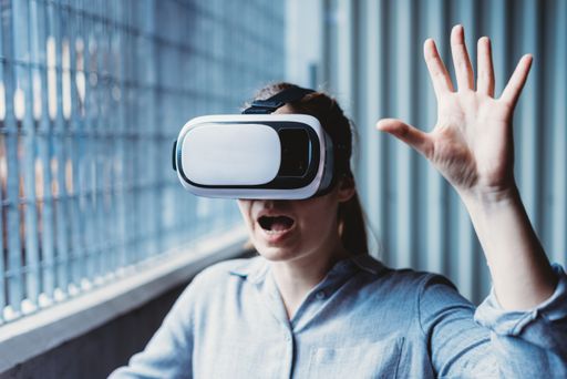 A closeup shot of a young female in virtual reality glasses in a parking