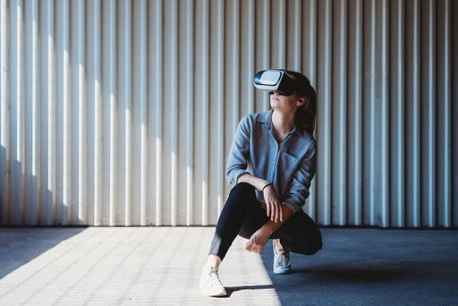A closeup shot of a young female in virtual reality glasses in a parking