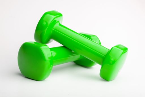 A closeup shot of green dumbells isoalted on a white backgound