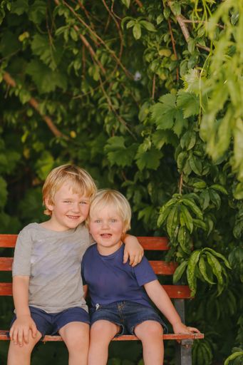 A selective focus of the adorable Australian little blue eyed  cheerful brothers hugging each other