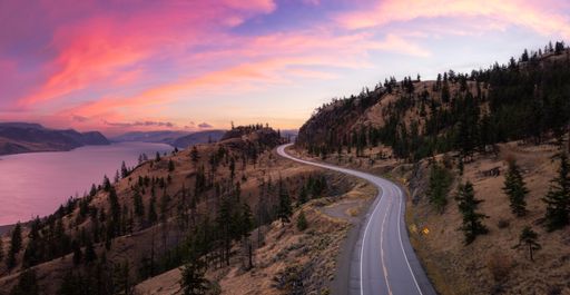 An aerial view of a highway in valley during sunrise in Kamloops, BC, Canada