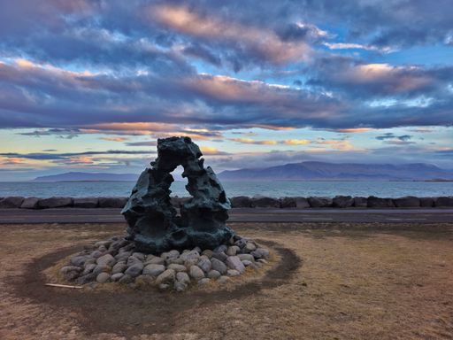 Stone circle on the seashore against the backdrop of a vibrant sky