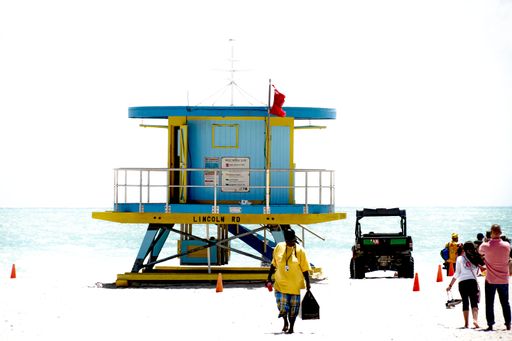 A closeup shot of a blue lifeguard hut on the beach