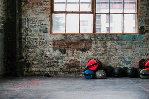 The weighted balls positioned beneath the window on a dilapidated wall.
