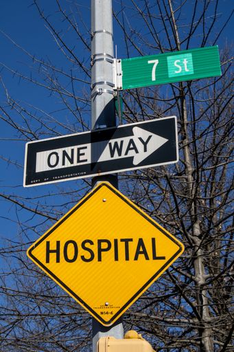 The street signs hanging from a pole on a roadside