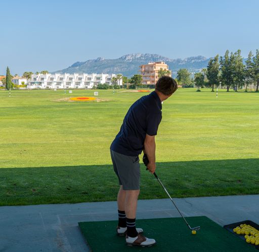 A closeup shot of a young male playing golf in the golf court