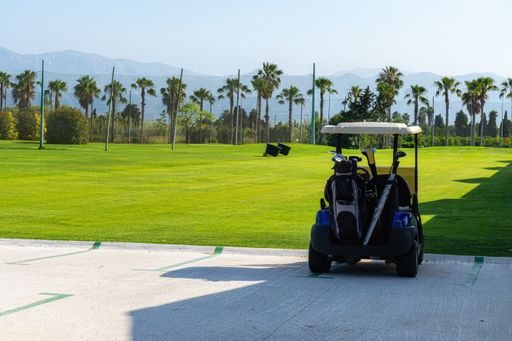 A closeup shot of a golf cart in the golf court under the sunlight
