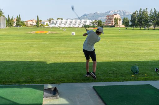 A closeup shot of a young male playing golf in the golf court