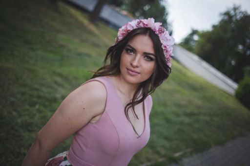 A shallow focus shot of a beautiful Caucasian female from Bosnia and Herzegovina in an elegant dress