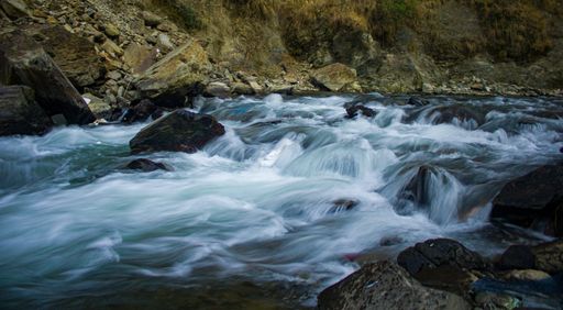 A closeup shot of a babbling river through rocks in a forest