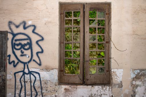 Old abandoned building in ruins, it is a dangerous site with black graffiti, Ricky Morty