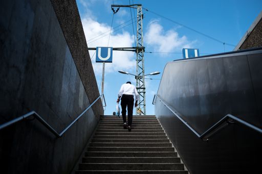 Old man going up to the railway station in Cologne.