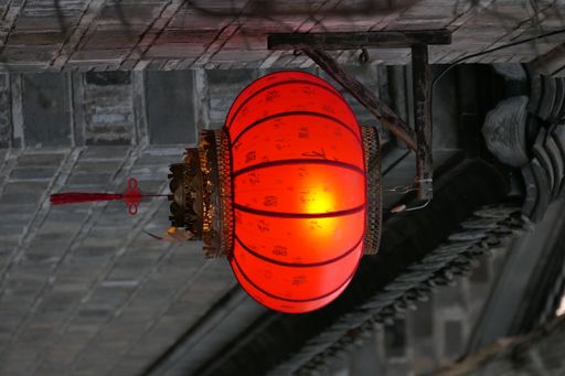 A red hanging lantern on the brick wall near the building in Nanjing, China