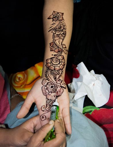 A vertical shot of a henna tattoo on a child's arm