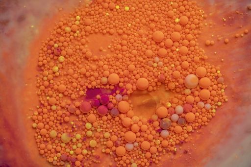 Bright and colorful abstract background from acrylic paints and oil mix, Macro bubble photography for wall art. Acrylic paint oil mix forming Bubble