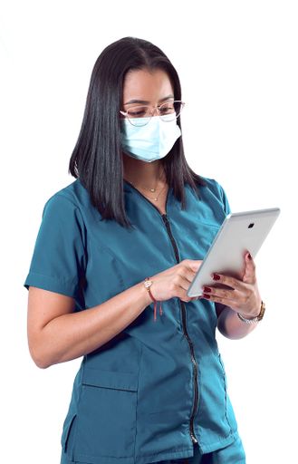 A vertical shot of a young Hispanic doctor/nurse wearing glasses and a sanitary mask using a tablet