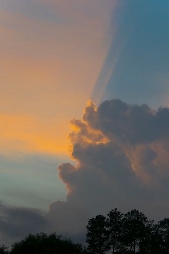Big Cumulonimbus clouds over rural Guatemala at sunset, blue sky, dramatic image.