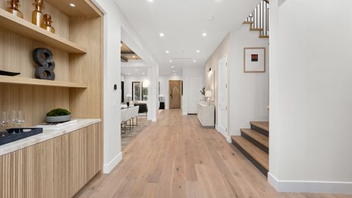 A hall with a staircase leading to the second floor of a home