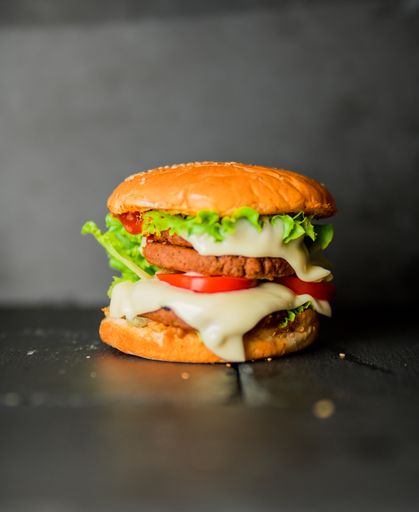 A studio shot of a juicy burger