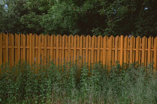 A selective focus shot of wooden fencing in a field