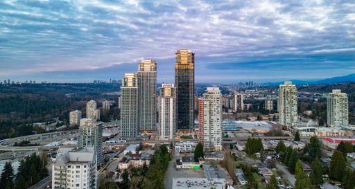 An aerial view of a modern downtown skyline under a cloudy sky