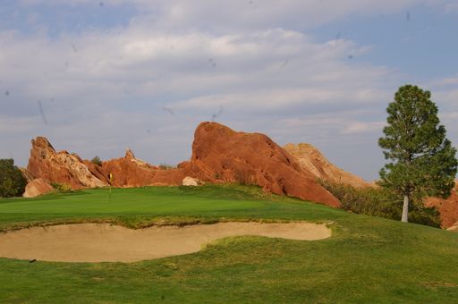 A golf course with rolling hills in the background, Denver