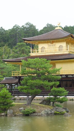 The beautiful Kinkaku-ji temple in a peaceful Japanese garden, encircled by a calm lake