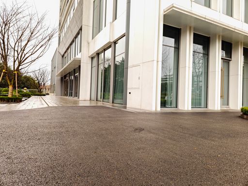 empty asphalt road in downtown of modern city during daytime. copy space for parking lot.