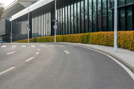 empty asphalt road in downtown of modern city during daytime. copy space for parking lot.