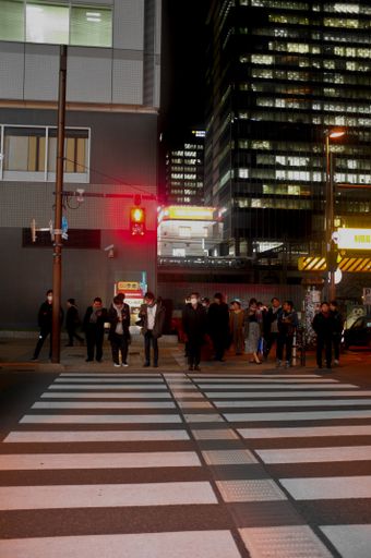 Japanese People waiting to cross a Street in January in Tokyo, Japan