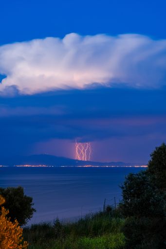 A vertical shot of an incoming storm at the city of Dikili, Turkey as seen from Lesvos, Greece