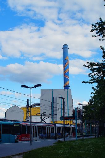 An underground train passes the 'Heddernheimer Landstrasse' station against the backdrop of the imposing waste incineration plant in Frankfurt.
