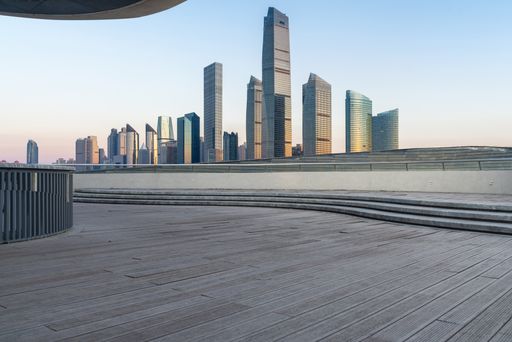 An empty concrete square with modern cityscape