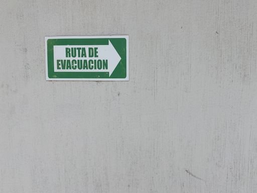 A closeup of an evacuation route sign on the wall