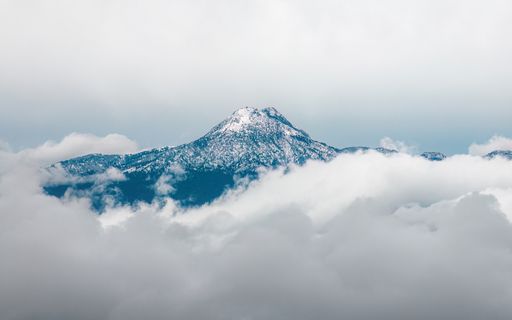 A scenic view of the majestic mountain hidden in the sea of clouds. Nevado de Colima, Mexico