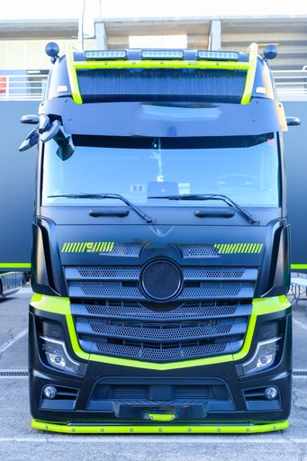 A black and green truck parked in a parking lot