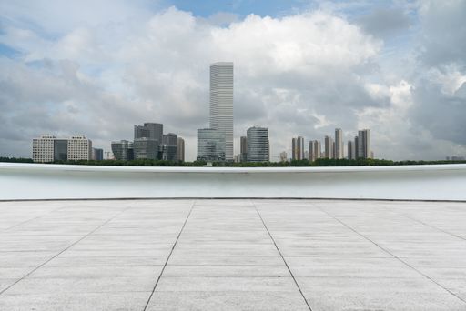 empty ground floor with modern cityscape and cloudy sky. empty copy space.