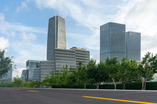 Empty asphalt road with modern office buildings in downtown. empty road for car advertising.