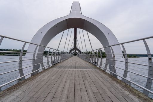 A bridge stretches over a lake, disappearing into the distance, Sweden, Soelvesborg