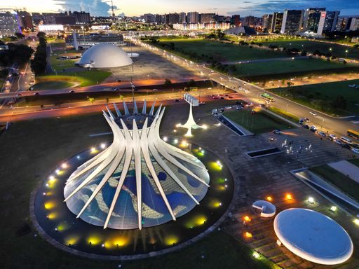 An aerial night view of the Cathedral of Brasília with city lights in the background, Brazil