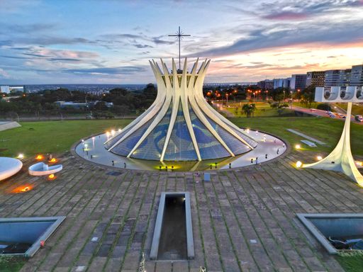 A night view of the Cathedral of Brasília with city lights in the background in Brasília, Brazil