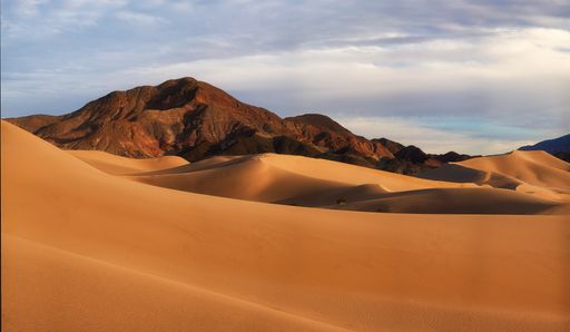 A Sunset light illuminating dunes in the desert
