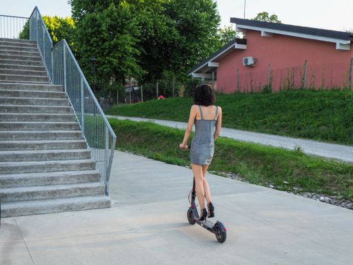 Young hispanic thin girl dressed elegant riding an  electric scooter