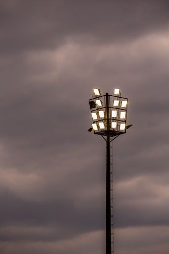 A vertical shot of sports stadium lights on a cloudy evening in Johannesburg, South Africa