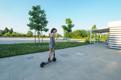 Young hispanic thin girl dressed elegant riding an  electric scooter