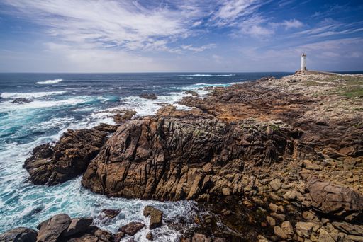 A beautiful shot of the Lighthouse of Roncudo on a cliff near the sea in Galicia, Spain